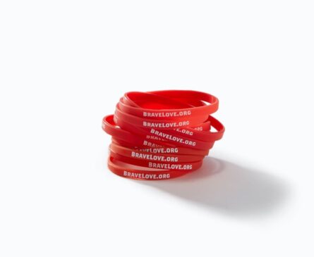 Stack of red rubber bracelets with 