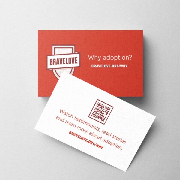 Two "Why Adoption? Pocket Notecards" on a grey background, one red and one white, featuring text and a QR code about adoption from Bravelove.org.
